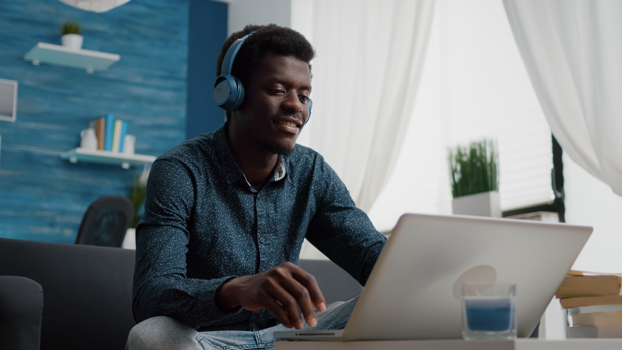 African american man with headphone on watching movie on streaming services